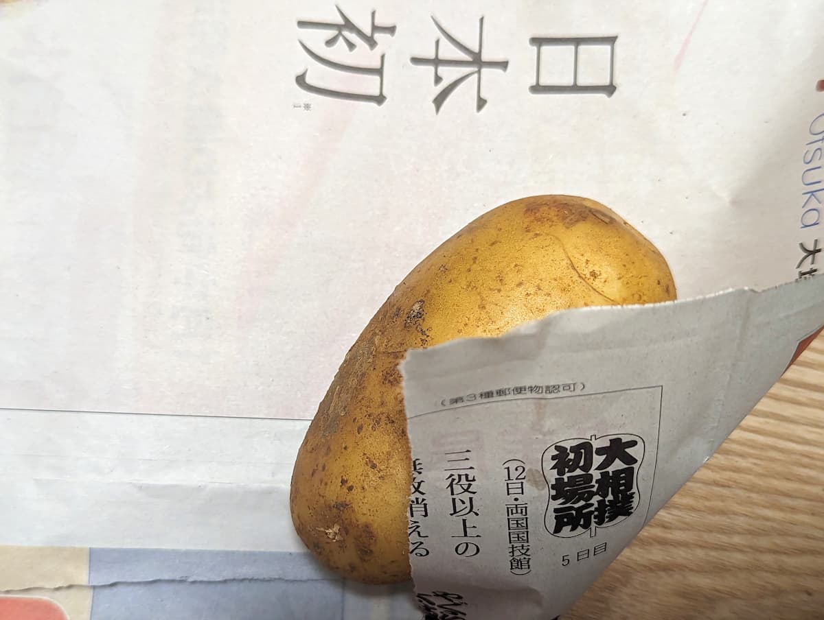 新じゃがいもを新聞紙に包む